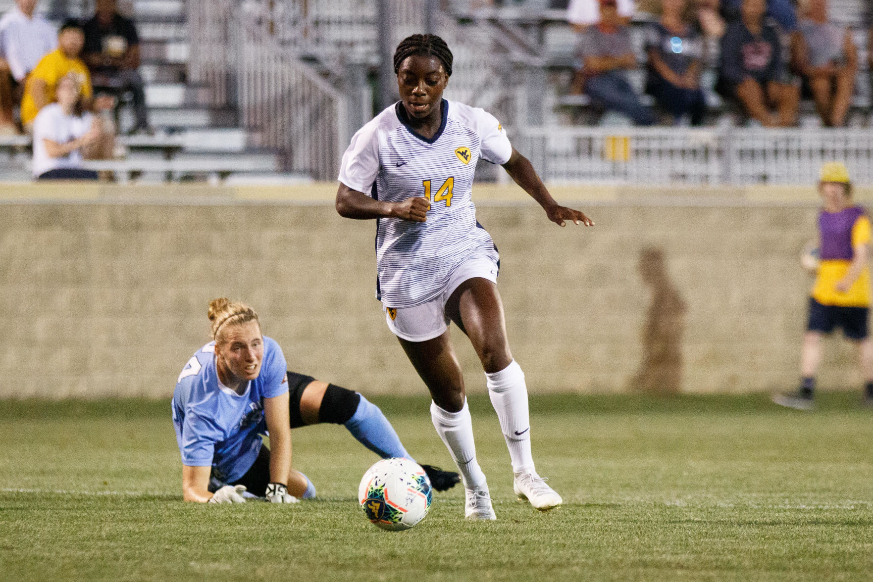 West Virginia forward Nicole Payne drives toward the net after faking out Stony Brook goalkeeper Sophia Manner.